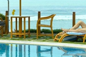 Guests relaxing by the pool and sea Guests relaxing by the pool and sea