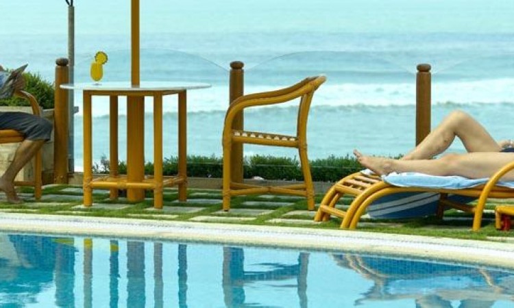 Guests relaxing by the pool and sea Guests relaxing by the pool and sea